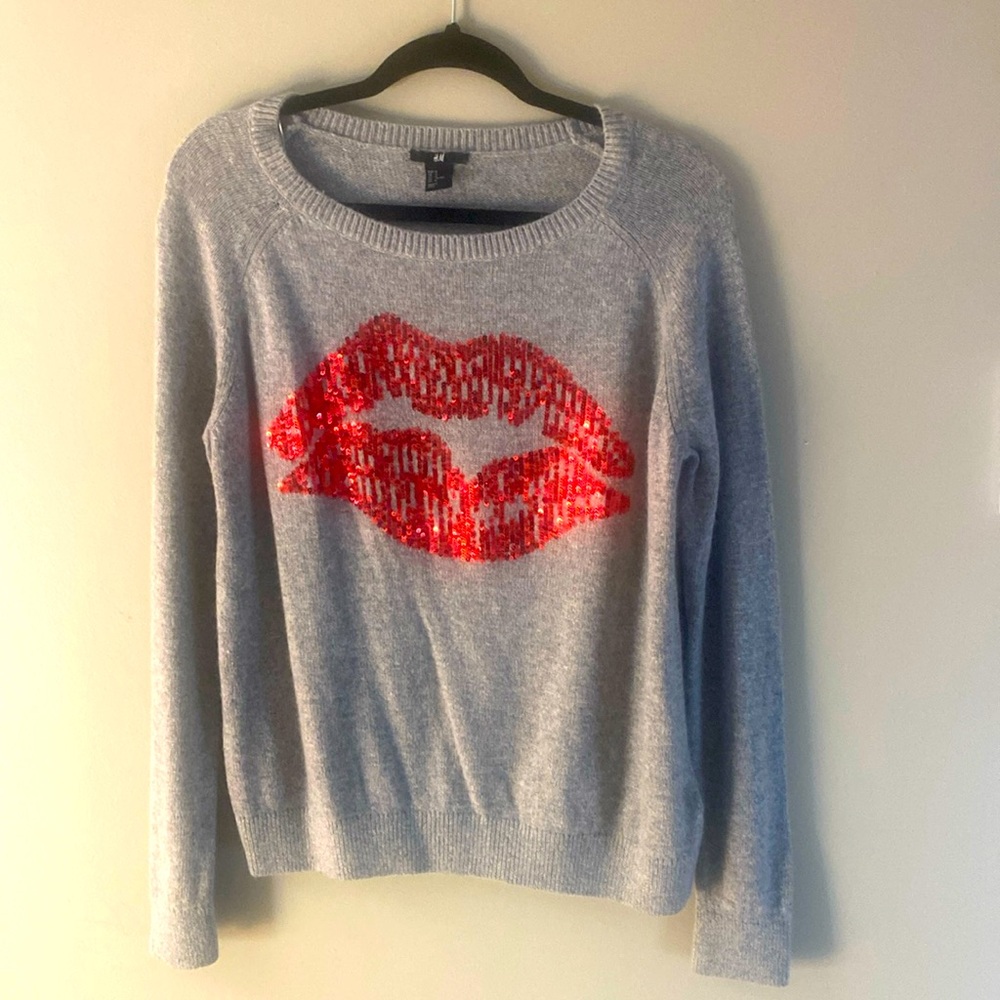 H&M gray sweater with red sequences shaped like a lip.